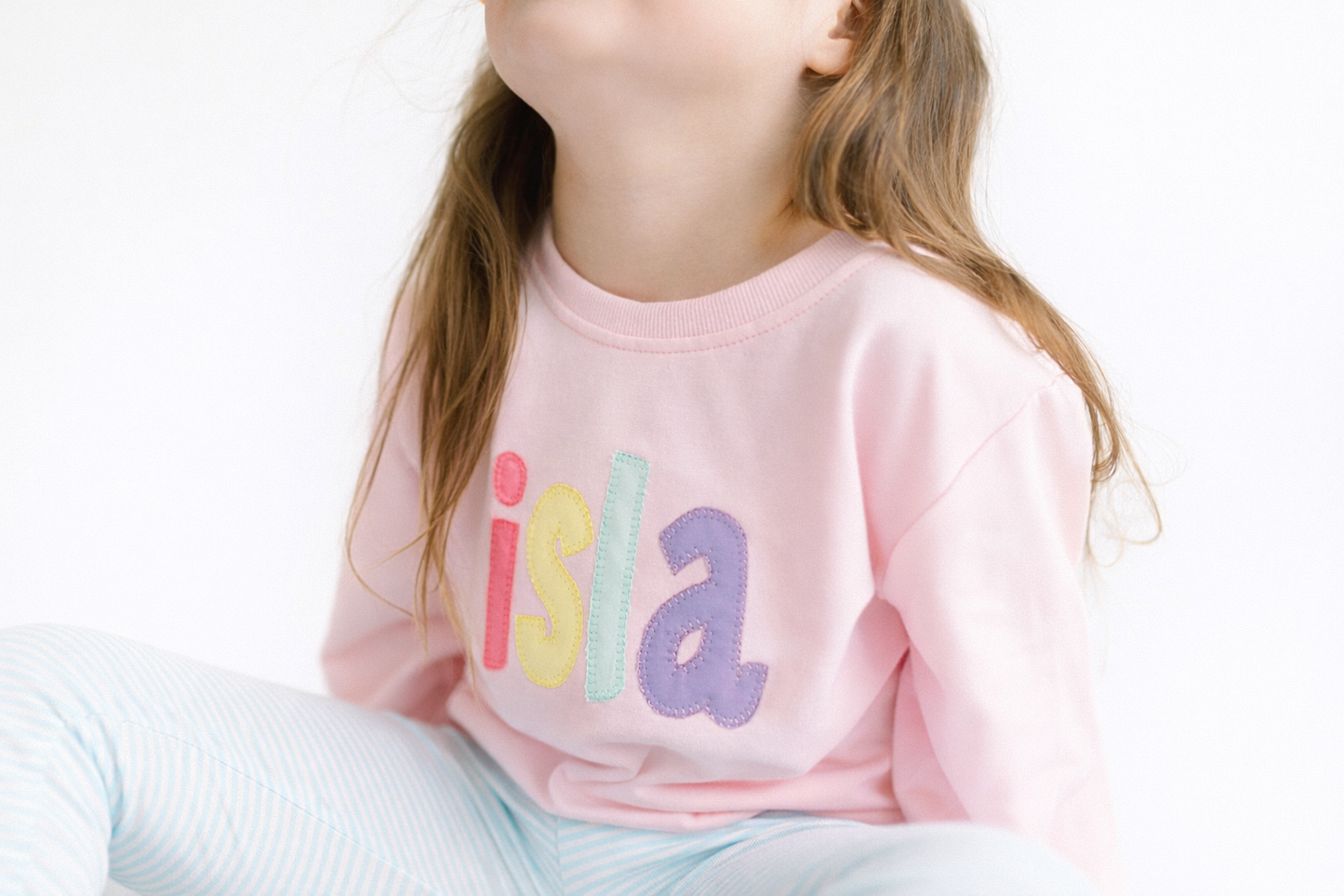Pink rainbow appliqué name sweatshirt